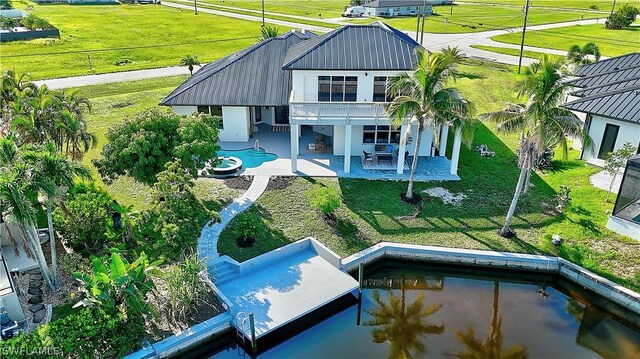 back of property featuring a patio area and a balcony