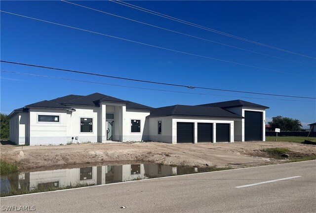 view of front of house with a garage and stucco siding