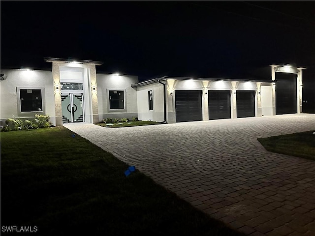 302 El Dorado Blvd N, Cape Coral, FL 33993 - view of front facade with a garage, decorative driveway, stucco siding, and a yard