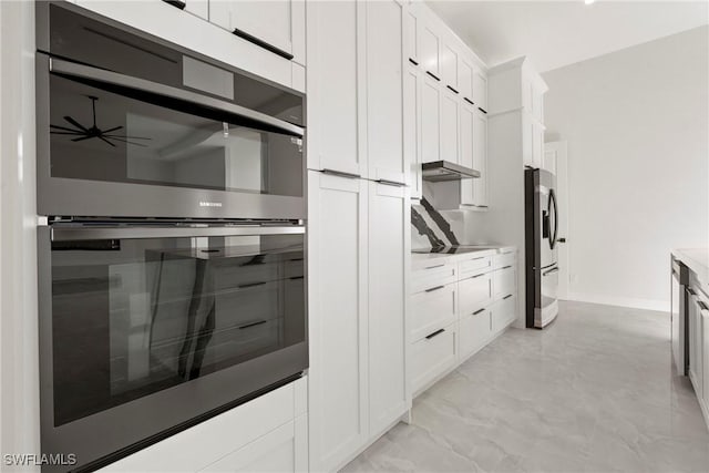 kitchen with light countertops, dobule oven black, white cabinets, under cabinet range hood, and stainless steel fridge with ice dispenser