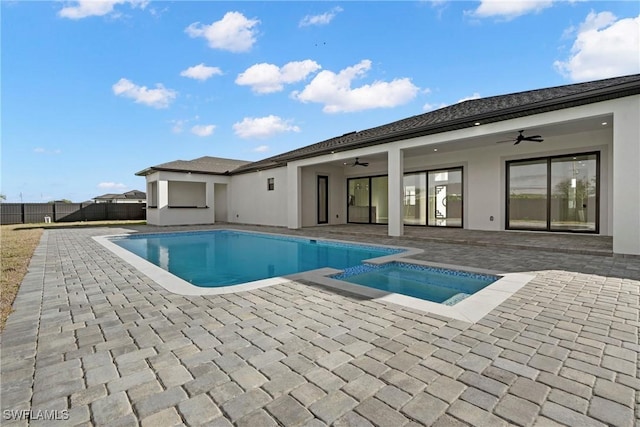 view of pool with ceiling fan, a patio area, and fence