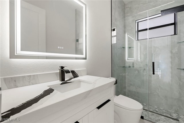 full bathroom with vanity, a marble finish shower, and toilet