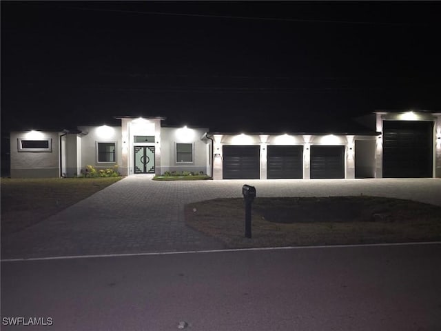 302 El Dorado Blvd N, Cape Coral, FL 33993 - view of front of property featuring driveway, a garage, and stucco siding
