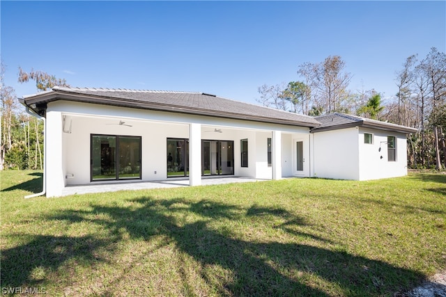 back of house featuring a yard, ceiling fan, and a patio