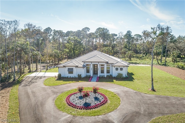 ranch-style home featuring a front yard