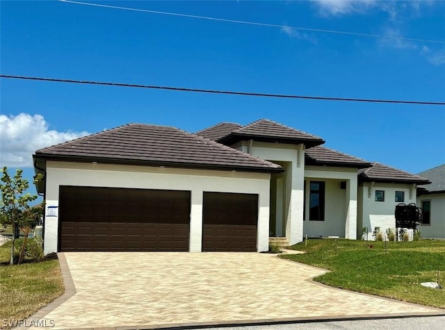 prairie-style house with a front yard and a garage