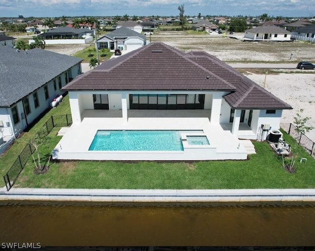 back of house with a patio, a water view, central AC unit, a yard, and a fenced in pool