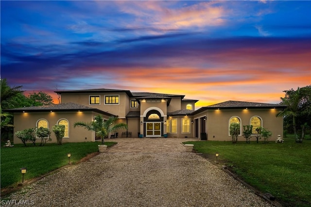 view of front of house featuring a lawn and a patio area