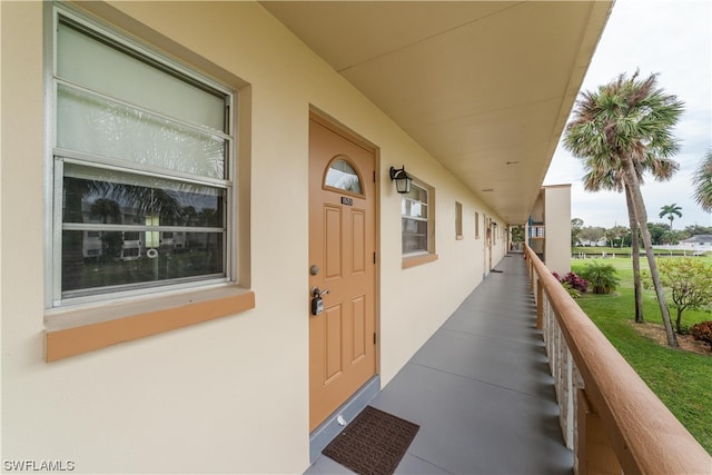 doorway to property featuring a lawn