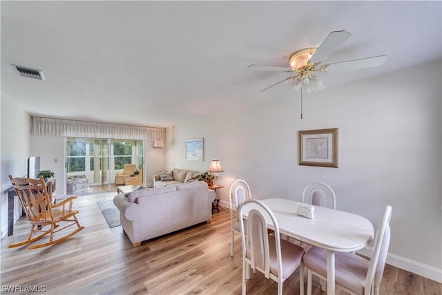 dining area with light hardwood / wood-style floors and ceiling fan