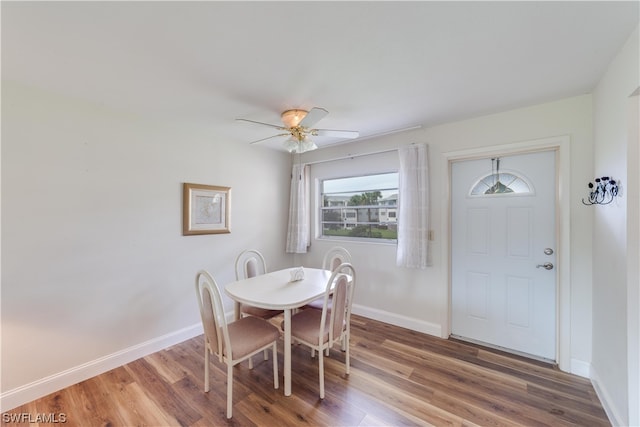 dining space with ceiling fan and dark hardwood / wood-style floors