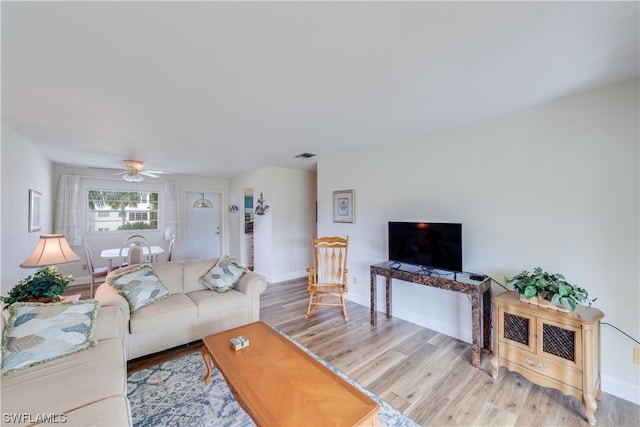 living room featuring ceiling fan and light hardwood / wood-style flooring