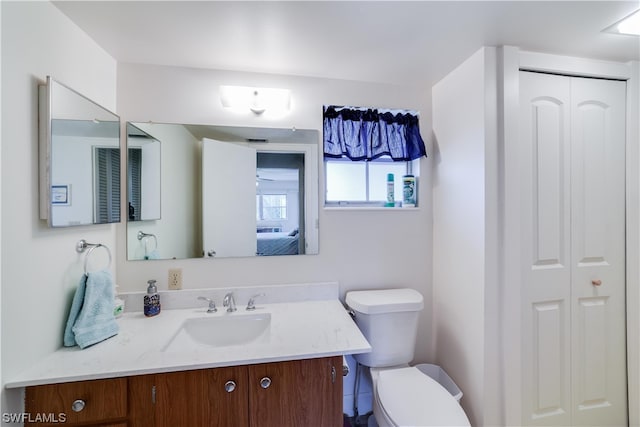 bathroom featuring toilet and vanity