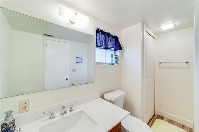 bathroom featuring toilet and vanity