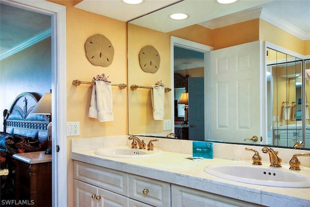 bathroom with crown molding, oversized vanity, and double sink