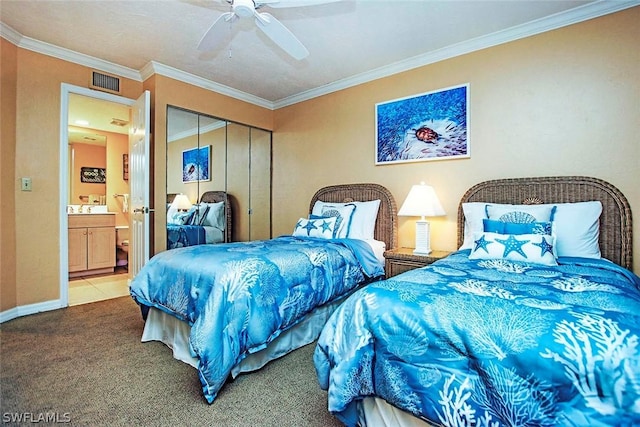 carpeted bedroom with ornamental molding, connected bathroom, a closet, and ceiling fan