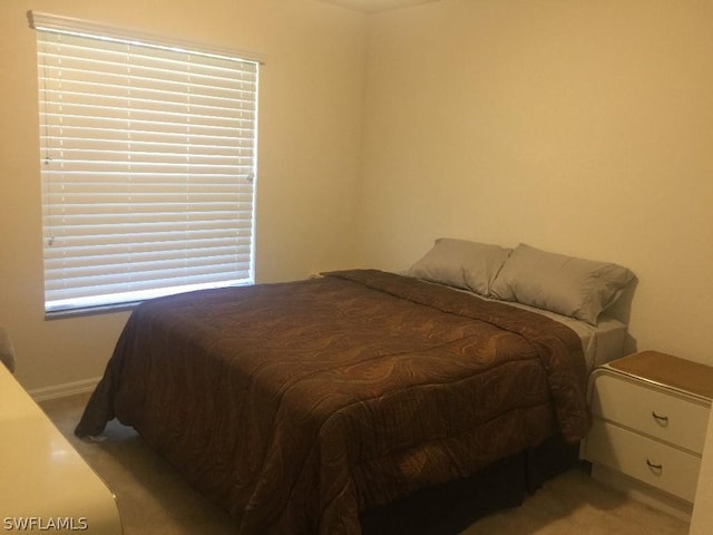 bedroom featuring light carpet