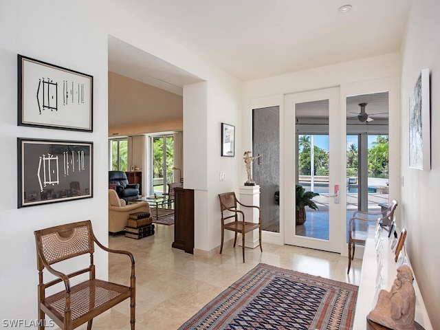 interior space featuring french doors, plenty of natural light, ceiling fan, and light tile flooring