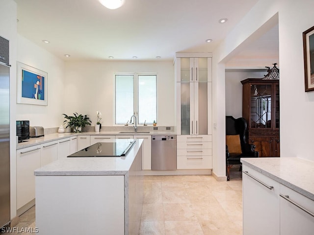 kitchen with a kitchen island, white cabinets, light tile floors, and black appliances