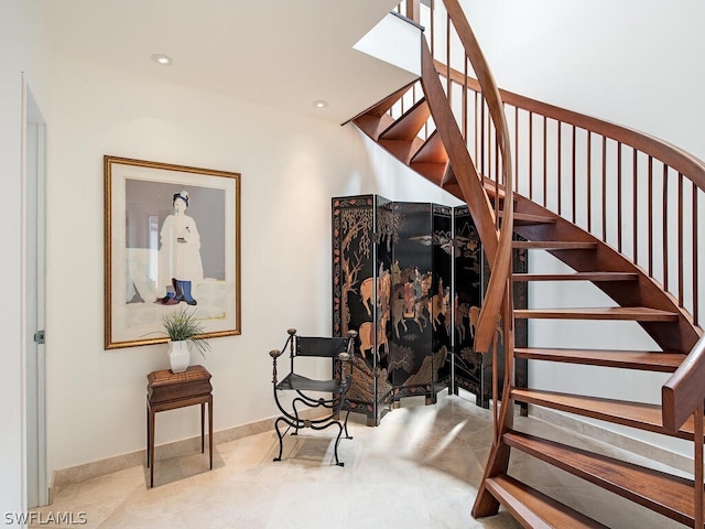 staircase featuring light tile flooring