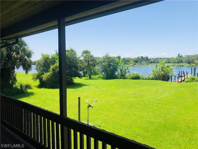 view of yard featuring a dock and a water view