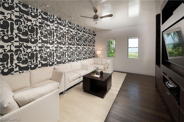 living room featuring ceiling fan and hardwood / wood-style flooring