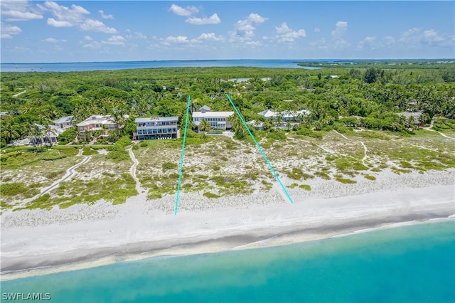 birds eye view of property featuring a water view and a view of the beach