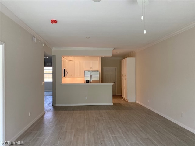 unfurnished living room with ornamental molding