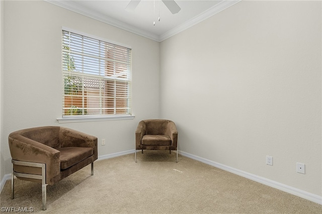 living area featuring crown molding, ceiling fan, and light colored carpet