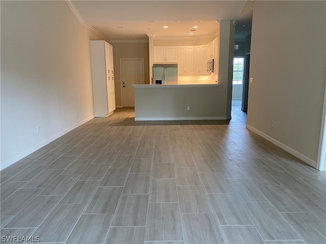 unfurnished living room featuring crown molding and light wood-type flooring