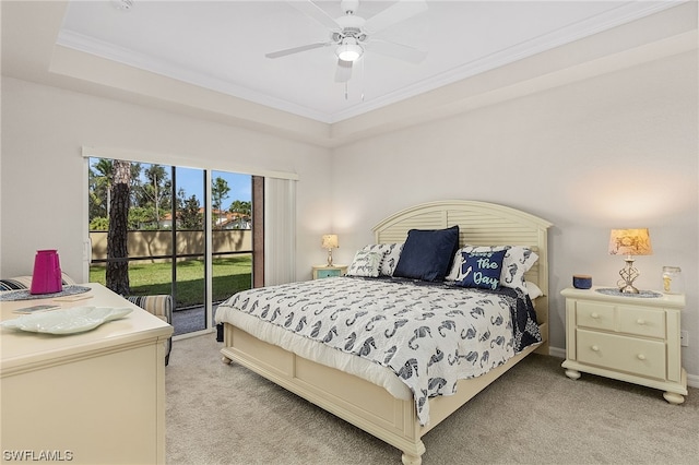 carpeted bedroom featuring a tray ceiling, access to exterior, ceiling fan, and crown molding