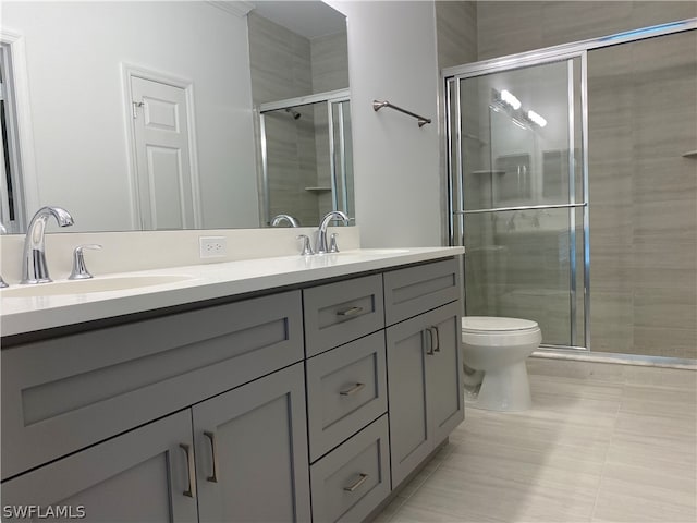 bathroom with double sink vanity, toilet, tile flooring, and walk in shower