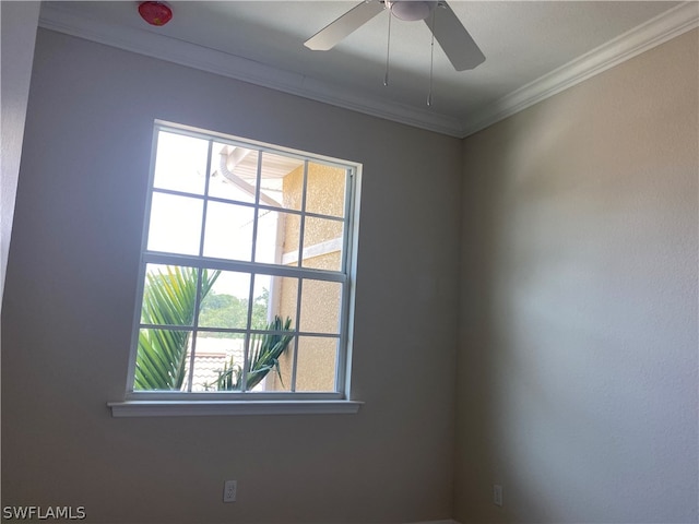 unfurnished room with ceiling fan and ornamental molding