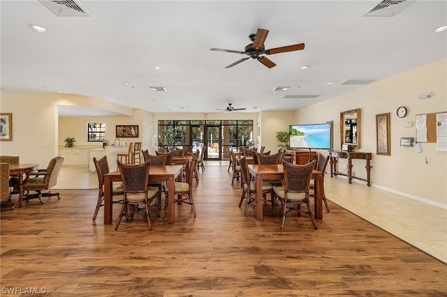 tiled dining space with ceiling fan