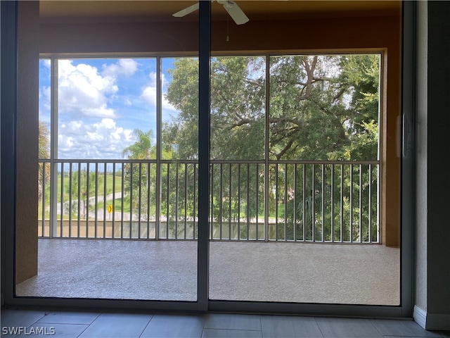 unfurnished sunroom featuring a healthy amount of sunlight and ceiling fan