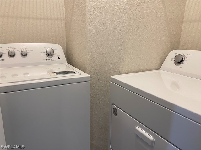 laundry room featuring separate washer and dryer