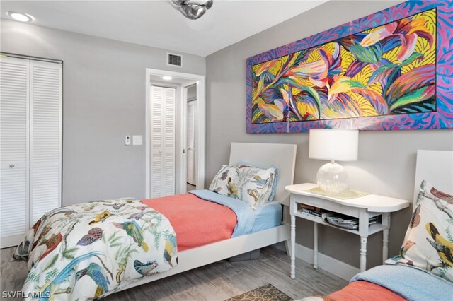 bedroom with hardwood / wood-style flooring and a closet