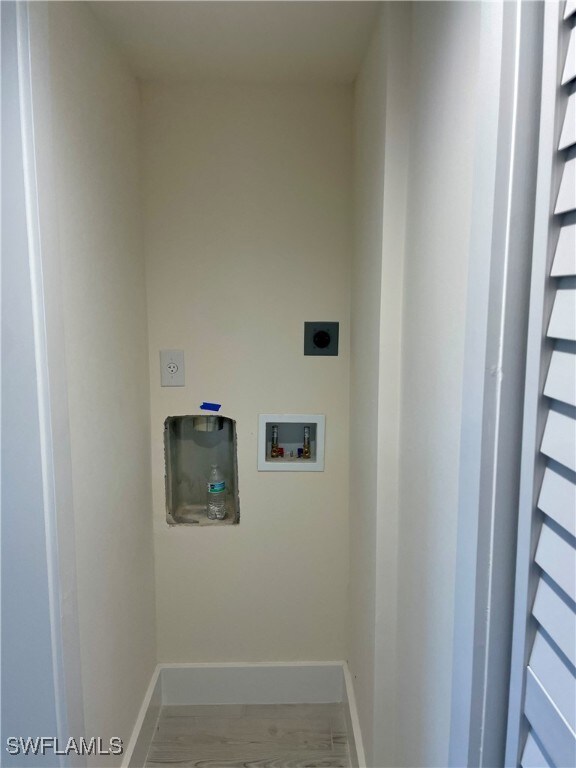 laundry room with hardwood / wood-style flooring, electric dryer hookup, and hookup for a washing machine