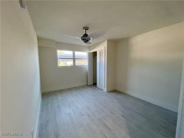 spare room with light hardwood / wood-style flooring and ceiling fan