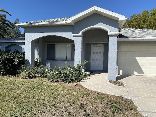 view of front of property with a front lawn and a garage