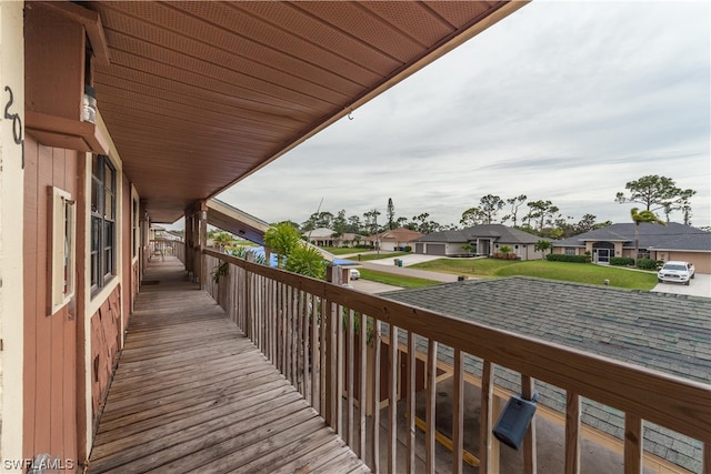 wooden deck featuring a yard