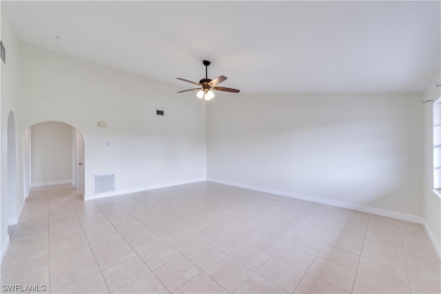 spare room featuring light tile floors, ceiling fan, and high vaulted ceiling