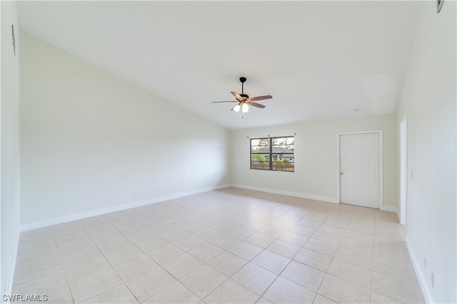 tiled spare room featuring ceiling fan