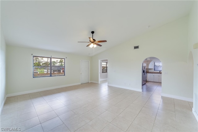 tiled spare room featuring ceiling fan and lofted ceiling