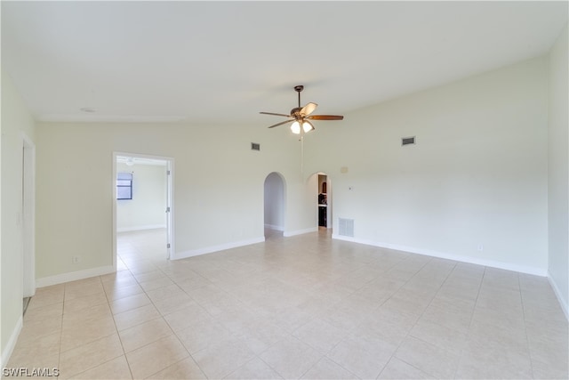 tiled spare room featuring ceiling fan and vaulted ceiling