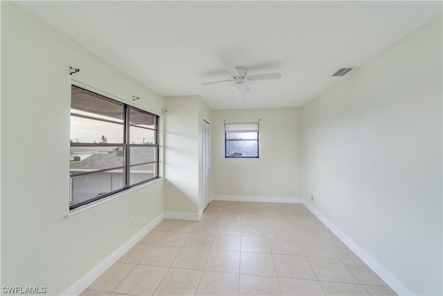 unfurnished room with ceiling fan and light tile floors