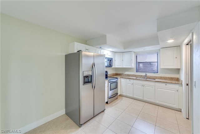 kitchen featuring appliances with stainless steel finishes, white cabinetry, sink, and light tile flooring