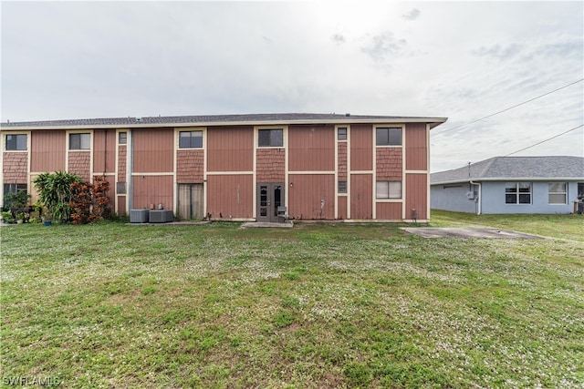 rear view of property featuring a yard