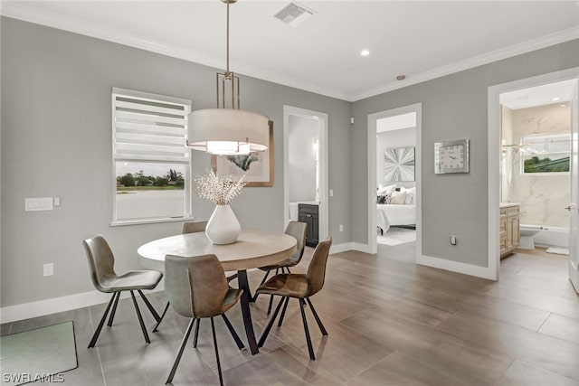 dining area featuring crown molding and a wealth of natural light