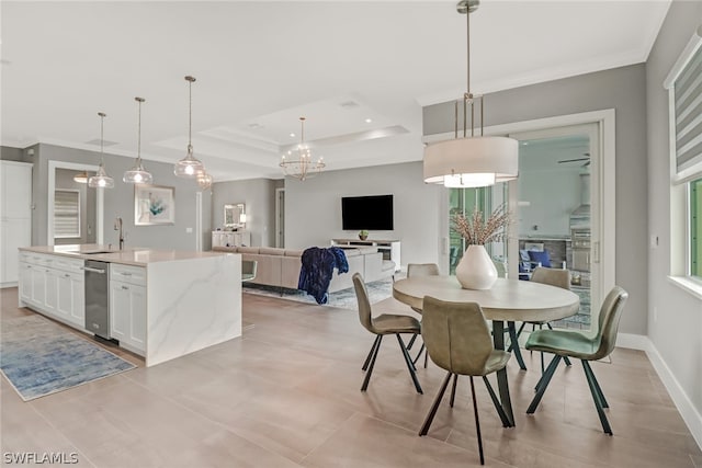 dining area featuring sink, light tile floors, crown molding, a tray ceiling, and an inviting chandelier